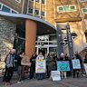 Protesters outside the housing tower at 33 Alfred Street, North Melbourne on Monday morning.